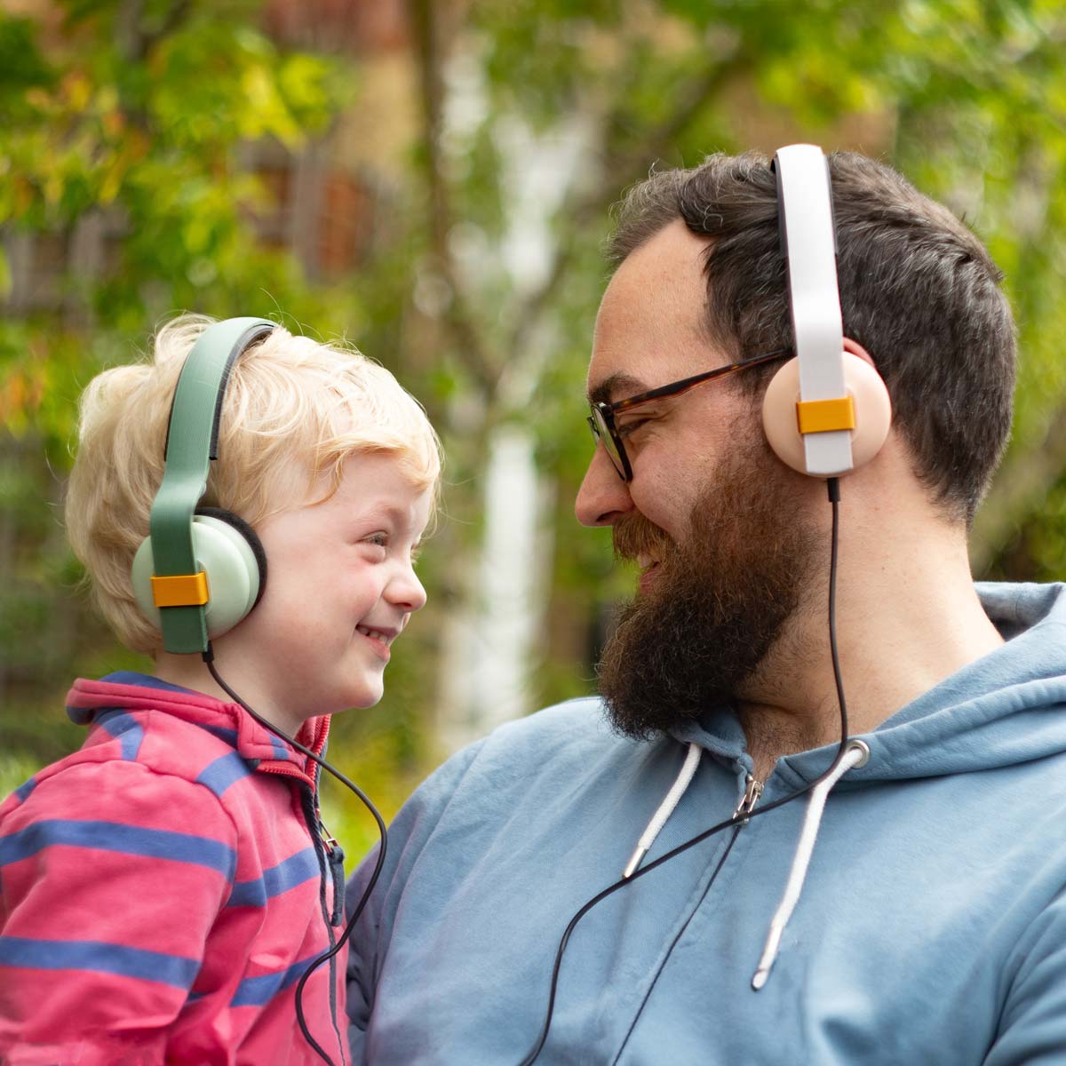 Two children sharing headphones