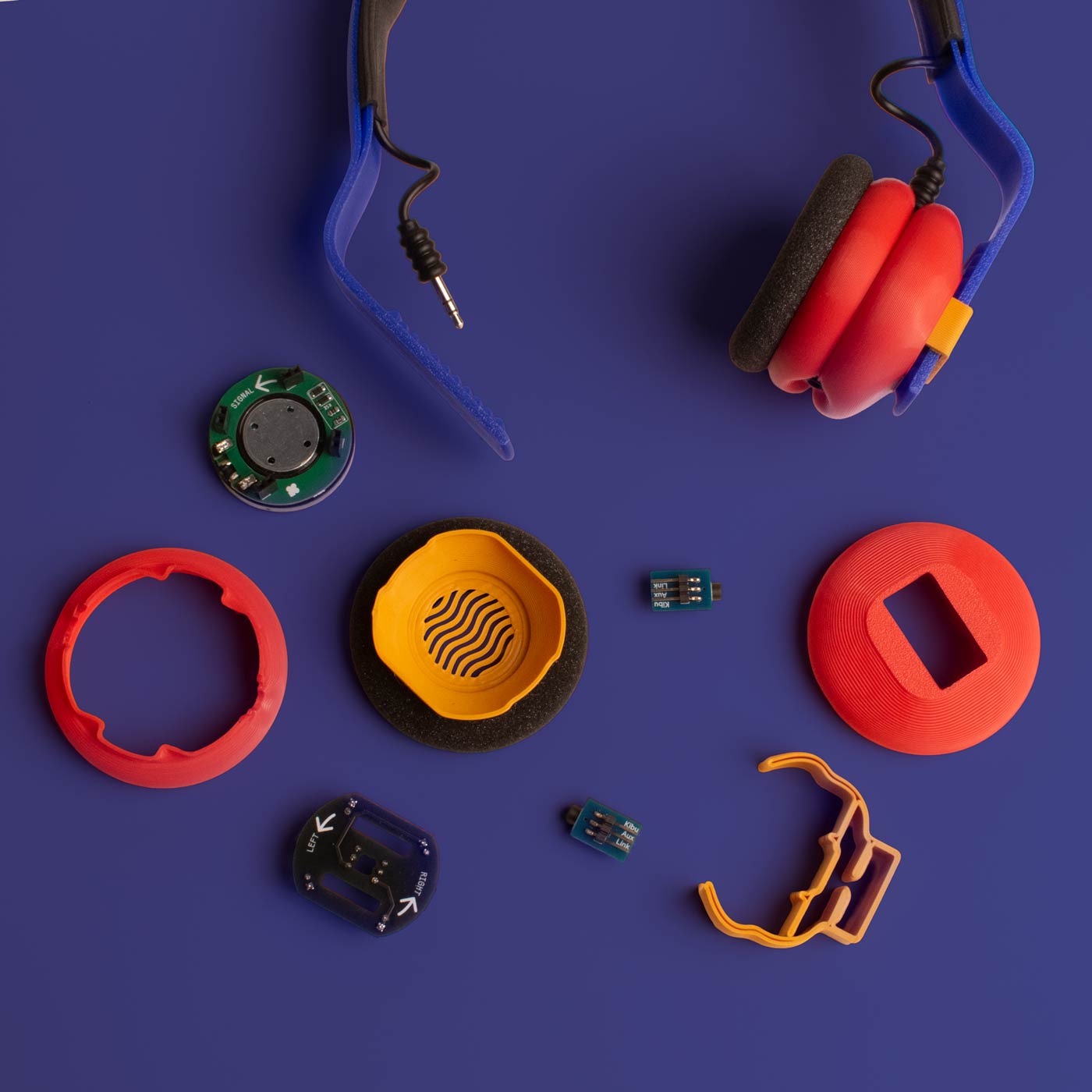 The parts of a Turbo Dash Kibu headphone kit laid out on a blue background
