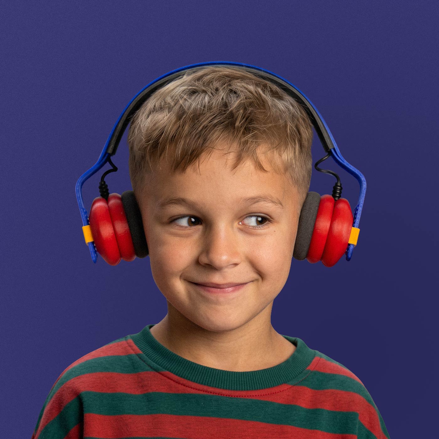 Boy smiling while wearing Kibu Turbo Dash headphones